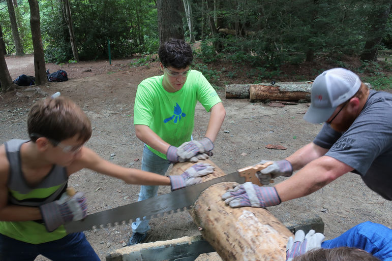 Chopping and sawing wood during the service component of last year’s Journey