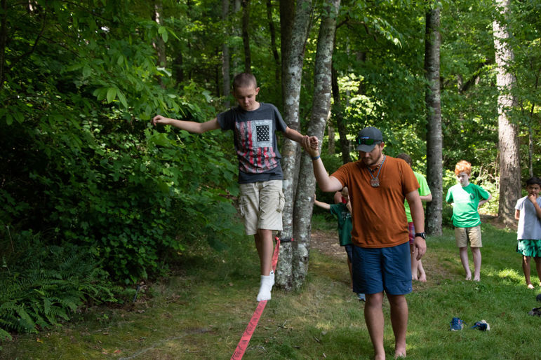 Brian helping boys find their balance while trying out slack lining