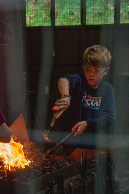 Concentrating hard at the blacksmith shop