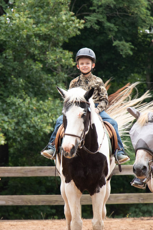 Nolan riding Wilbur in the ring during his morning class
