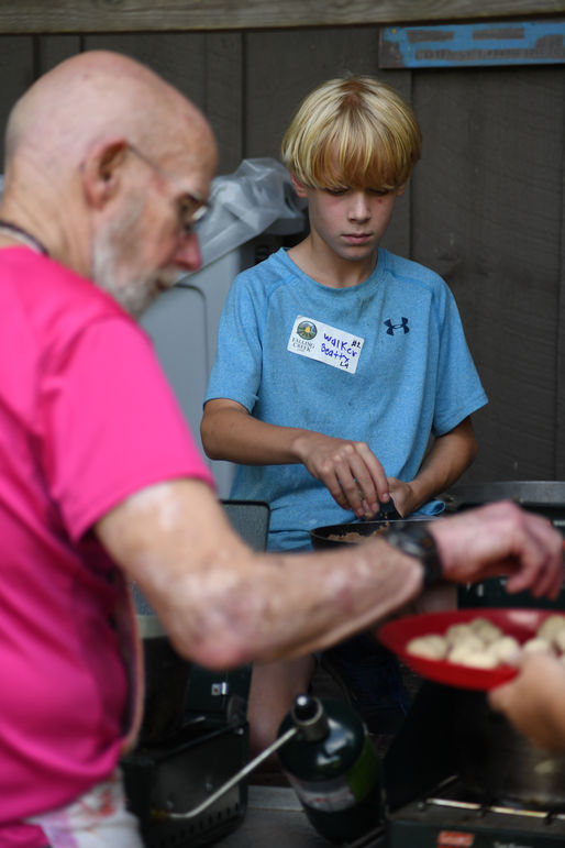Steve Longenecker, left, has been teaching boys how to cook these fried dough