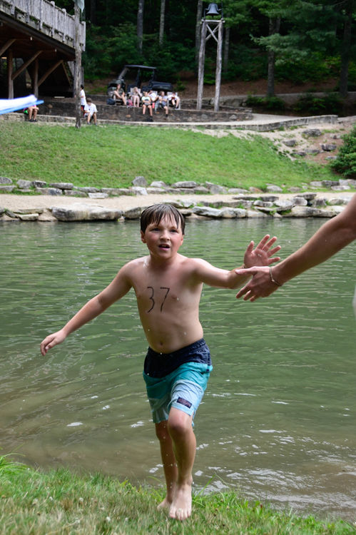 Getting high fives after swimming the lake course for Ironman training