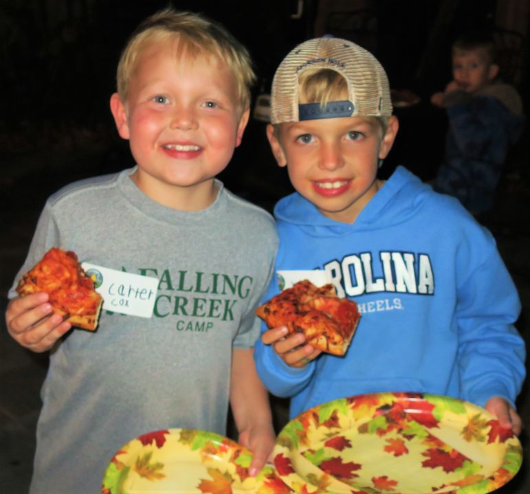 Camp friends enjoying some pizza before watching the updated camp movie.