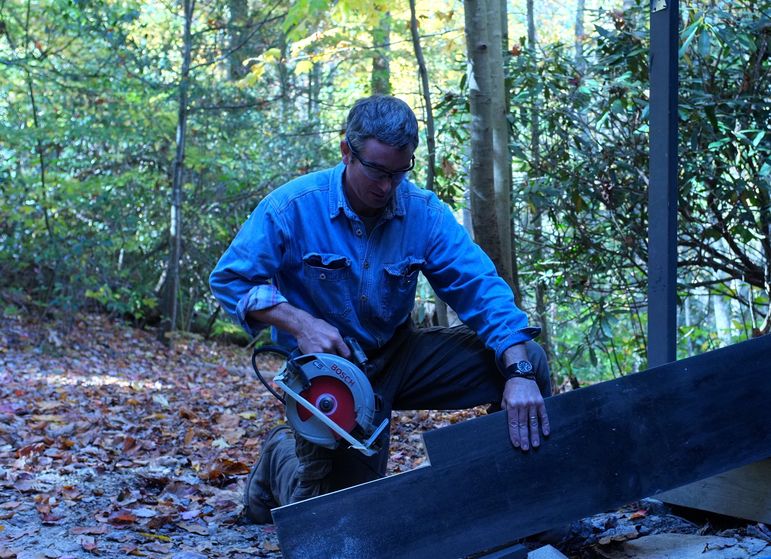 Bill Wilson making progress on the repairs to the campers cabins