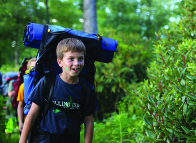Camper backpacking on our camp property.