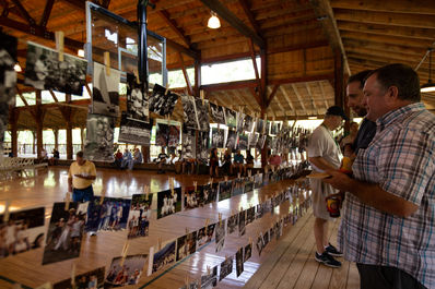 Simon Wilson looking over the decades of pictures strung around the McGrady Gym