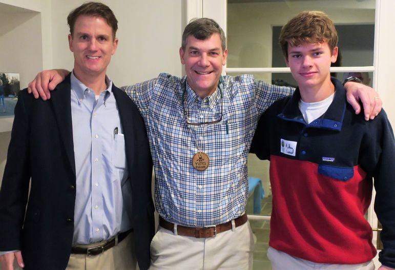FCC alumnus Paul Leonard (left) and his son Matthew reconnect with Yates and other FCC families.