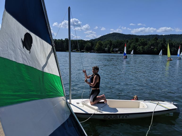 Hunter raising the main sheet on his sailboat