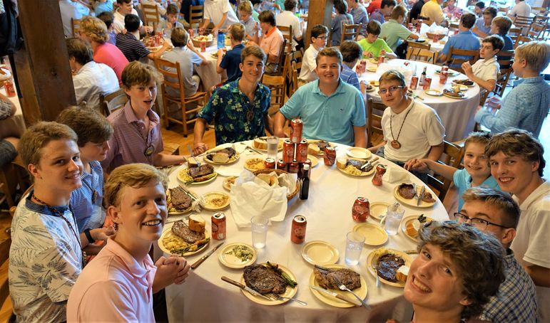 Eating some fresh-off-the-grill steaks and enjoying each other’s company at 5 Year Dinner