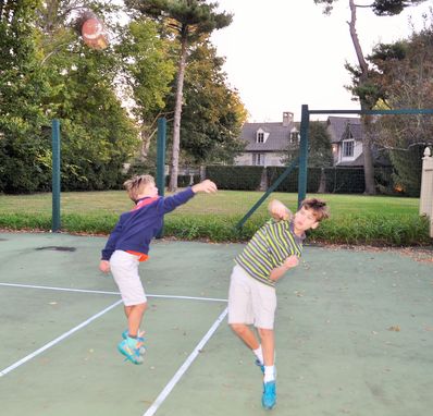The boys played football while families were arriving and mingling.