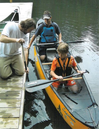 John teaching paddling at Father/Son Weekend