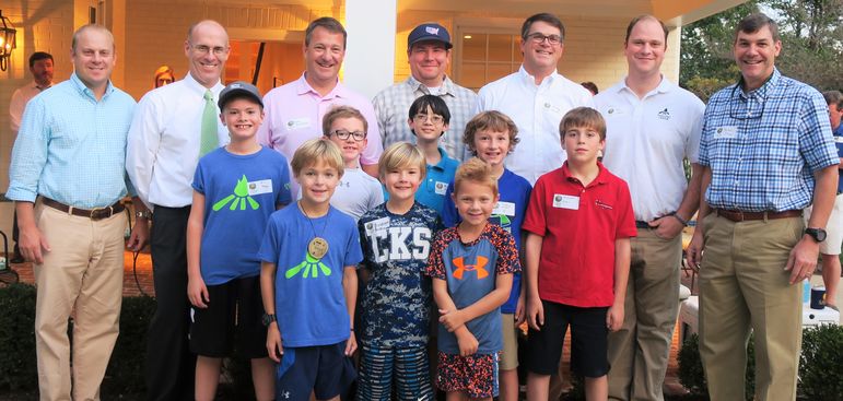 Boys who are returning to Falling Creek paused momentarily to take their photo with some of the boys who came tonight to learn more about FCC. Dads who have attended the Father/Son Weekend jumped in with the group as well.