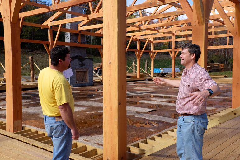 Rhett Pace (left), the project superintendent from Platt Architecture, gives Yates an update on the construction status